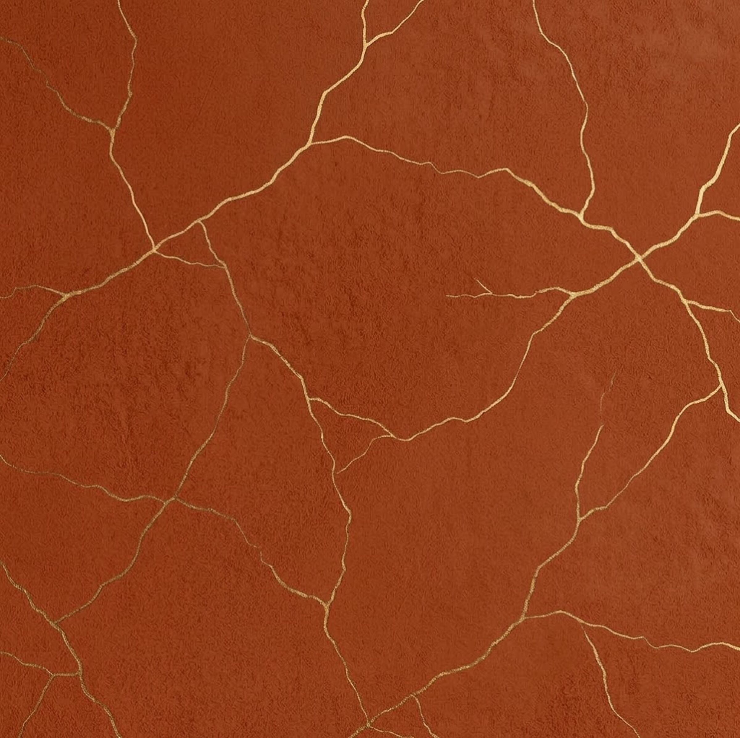 A rust and terracotta textured surface crossed by fine lines of gold kintsugi repair