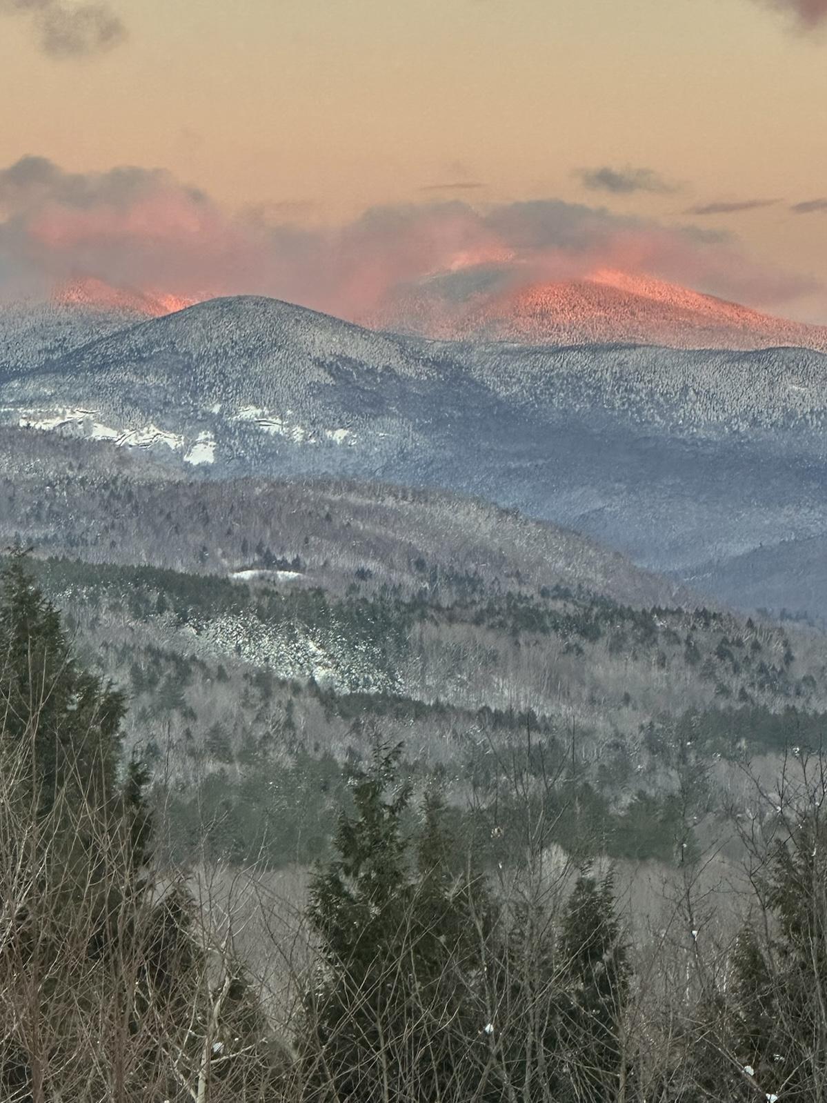 Pink-lit mountains at sunset — a moment of transformation